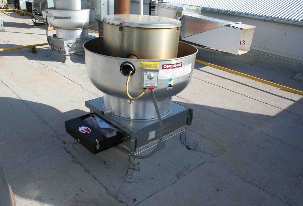 Installed DRIPLOC rooftop grease containment system on a commercial exhaust fan